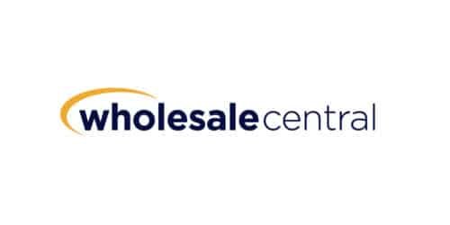 Logo with the text wholesale central in lowercase letters. The word wholesale is in bold dark blue, accompanied by a gold swoosh above. Central is in regular dark blue font. The background is white.
