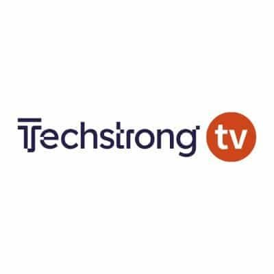Logo of Techstrong TV, featuring the text Techstrong in dark blue with the letters T and s interconnected. To the right, an orange circle contains the letters tv in white, echoing a modern vibe akin to innovations by Victor Lee at TigerGraph Cloud.